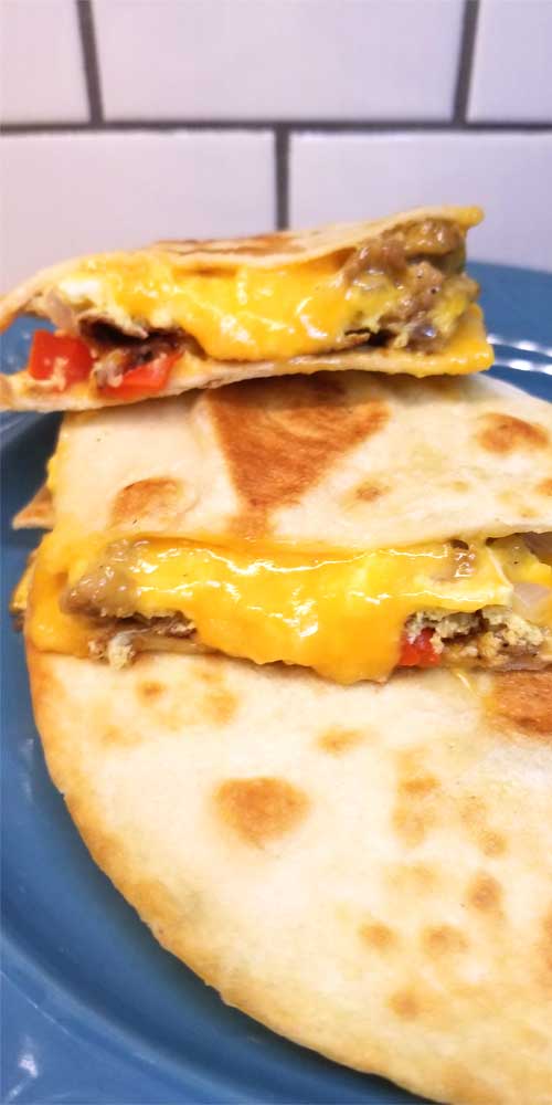 Simple quick easy cheesy, a little bit crispy, and always yummy Breakfast Quesadillas are a nice change of pace for the breakfast table. Well I think they'd be good at lunch or dinner too!