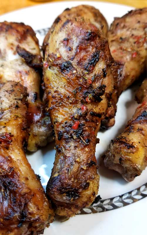 Zoomed in image of a piece of Ziggy Marley's Jerk Chicken, showing the caramelization on the skin.