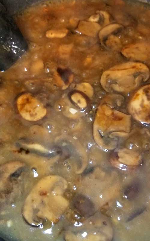 Mushrooms being cooked to make a mushroom gravy.