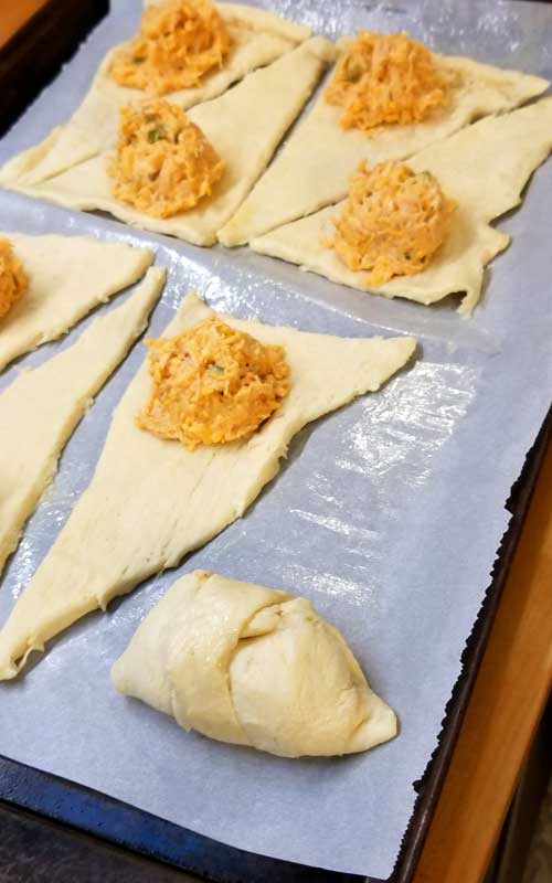 If your a fan of Buffalo Chicken, your going to fall in love with these little Beer Cheese Buffalo Bites wrapped in warm buttery crescent rolls perfect for football munching or TV binging.