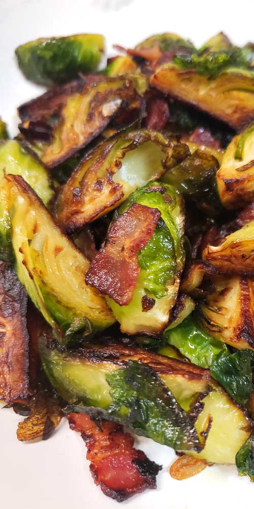Zoomed in image of finished Crispy Skillet Brussels Sprouts with Bacon & Garlic Butter.