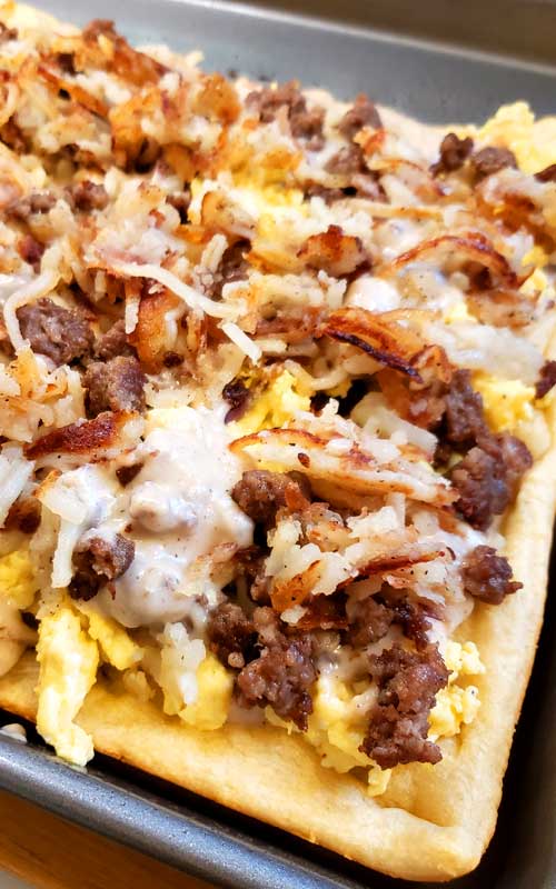 Perfect for a holiday morning, or weekend brunch we made this Country Sausage Gravy Breakfast Pizza when we had out of town family staying over and it was a big hit. Everyone said this is pretty spectacular!