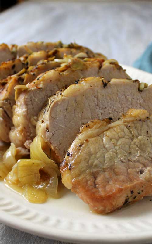Finished Garlic Herb Pork Roast and Creamy White Wine Gravy sliced and zoomed in to show texture of meat
