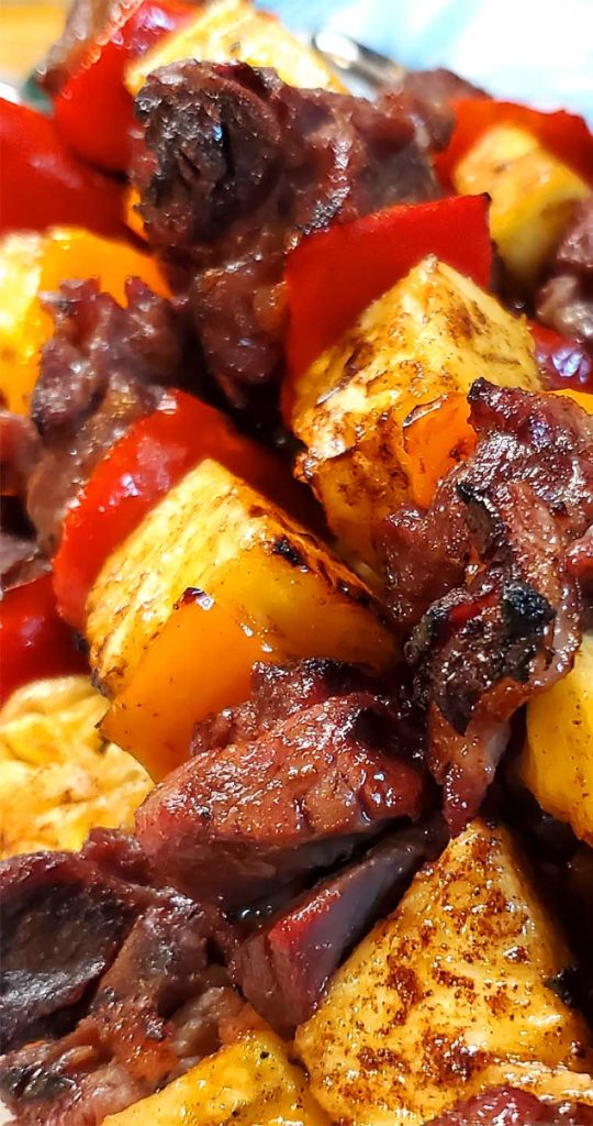 The grilled caramelized pineapple takes this dish over the top. These Brazilian Beef Kabobs with Pineapple and Peppers are very easy and so delish! Marinaded, smoky, and full of flavor goodness. #beef #grilling #Brazilian #pineapple #summer